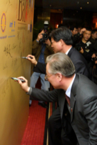 Chinese officials signing The Ball backdrop.